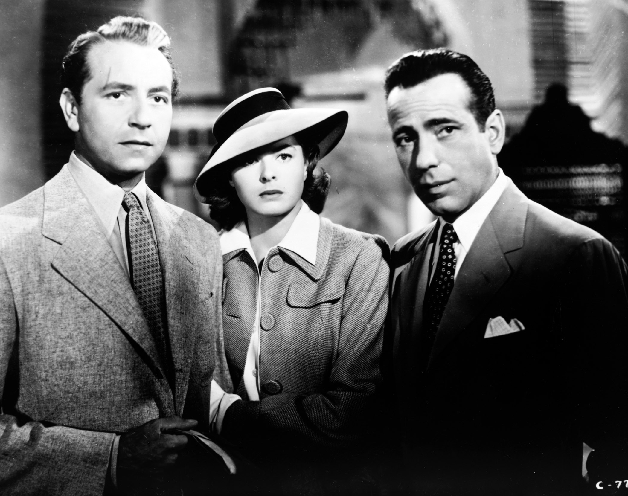 Medium shot of Paul Henreid as Victor Laszlo, Ingrid Bergman as Ilsa Lund, wearing hat, and Humphrey Bogart as Rick Blaine.